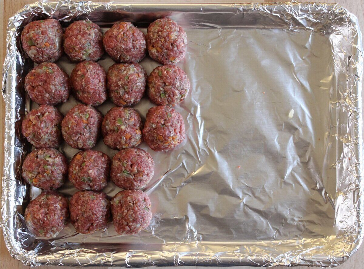 uncooked meatballs on baking sheet