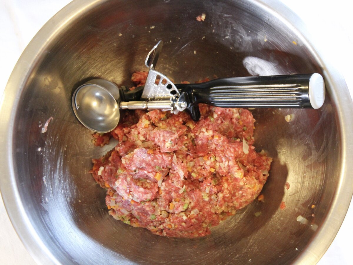 bowl with raw meatball mixture