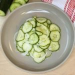 close up of bowl of marinated cucumbers and onions.