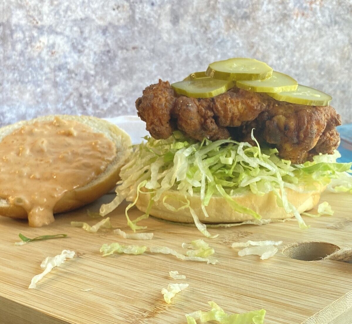 fried chicken sandwich with a saucy bun