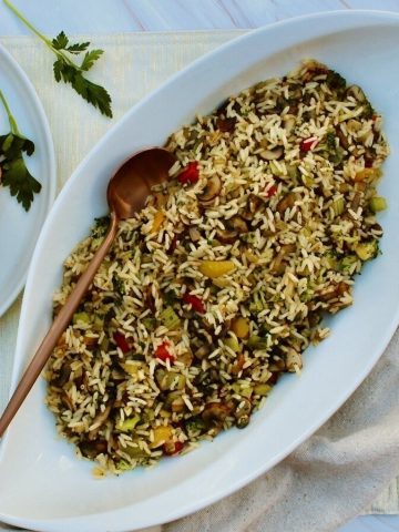 garden vegetable rice in dish next to roasted chicken.