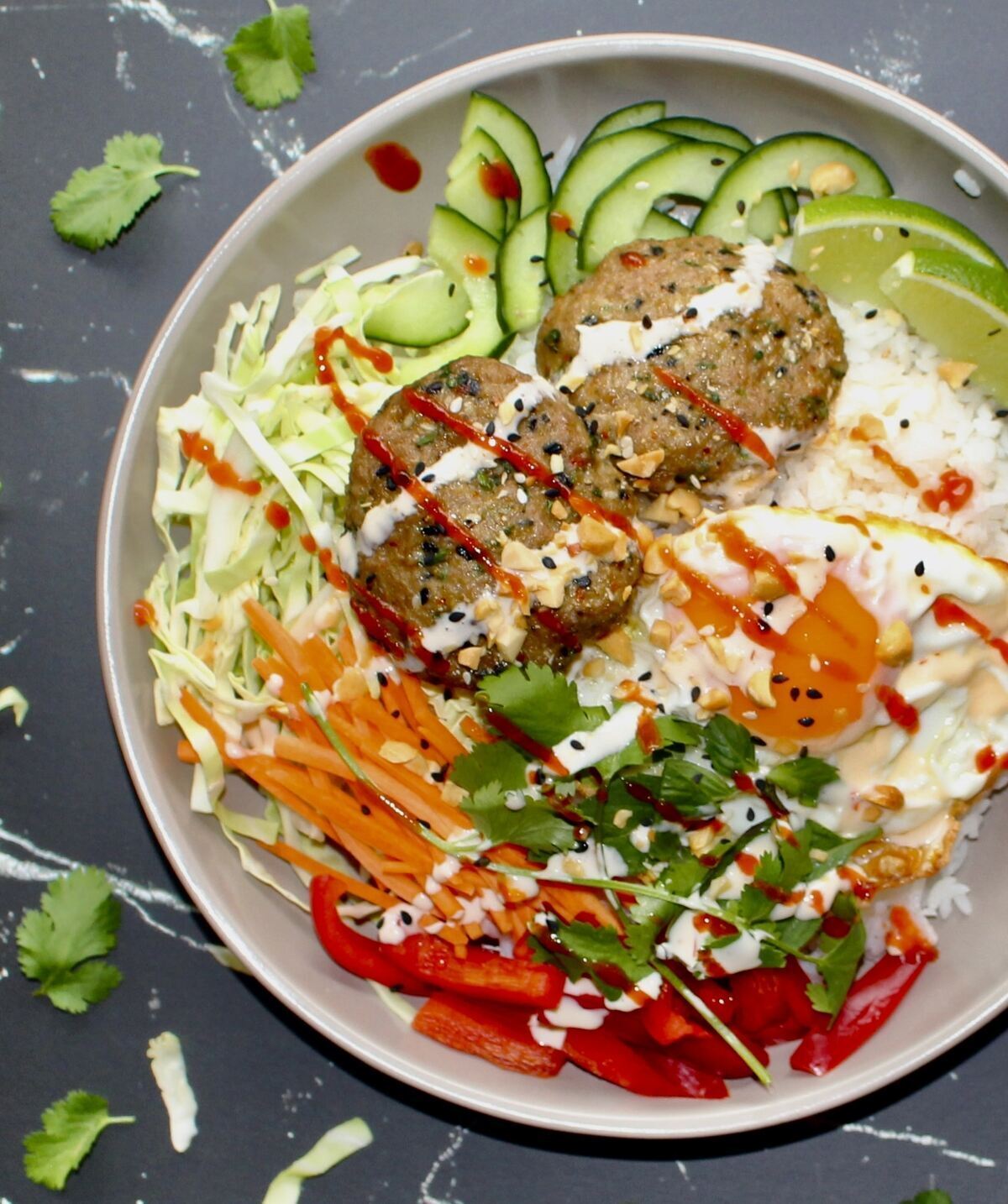 close up picture of thai inspired pork patty rice bowl.