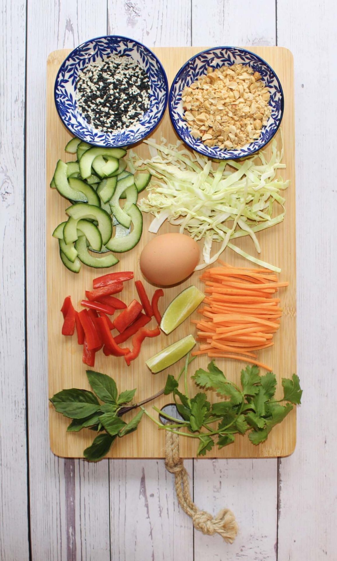 Wood board full of toppings ideas for thai-inspired pork patty rice bowl.