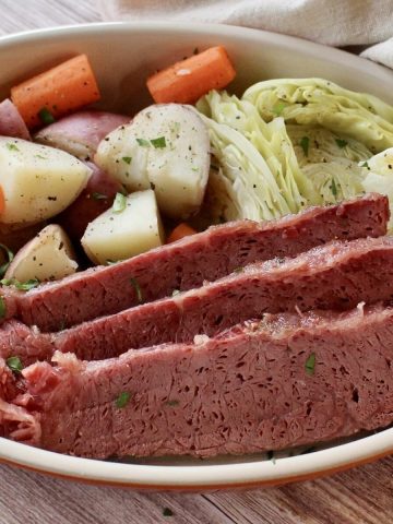 Feature photo for roasted corned beef with vegetables in a dish.