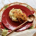 single serving of anglesey eggs on a plate with spoon and napkin.