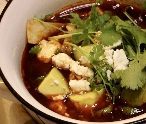 Chicken tortilla soup in a bowl with a spoon.