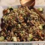 Closeup of farro salad in bowl with spoon.