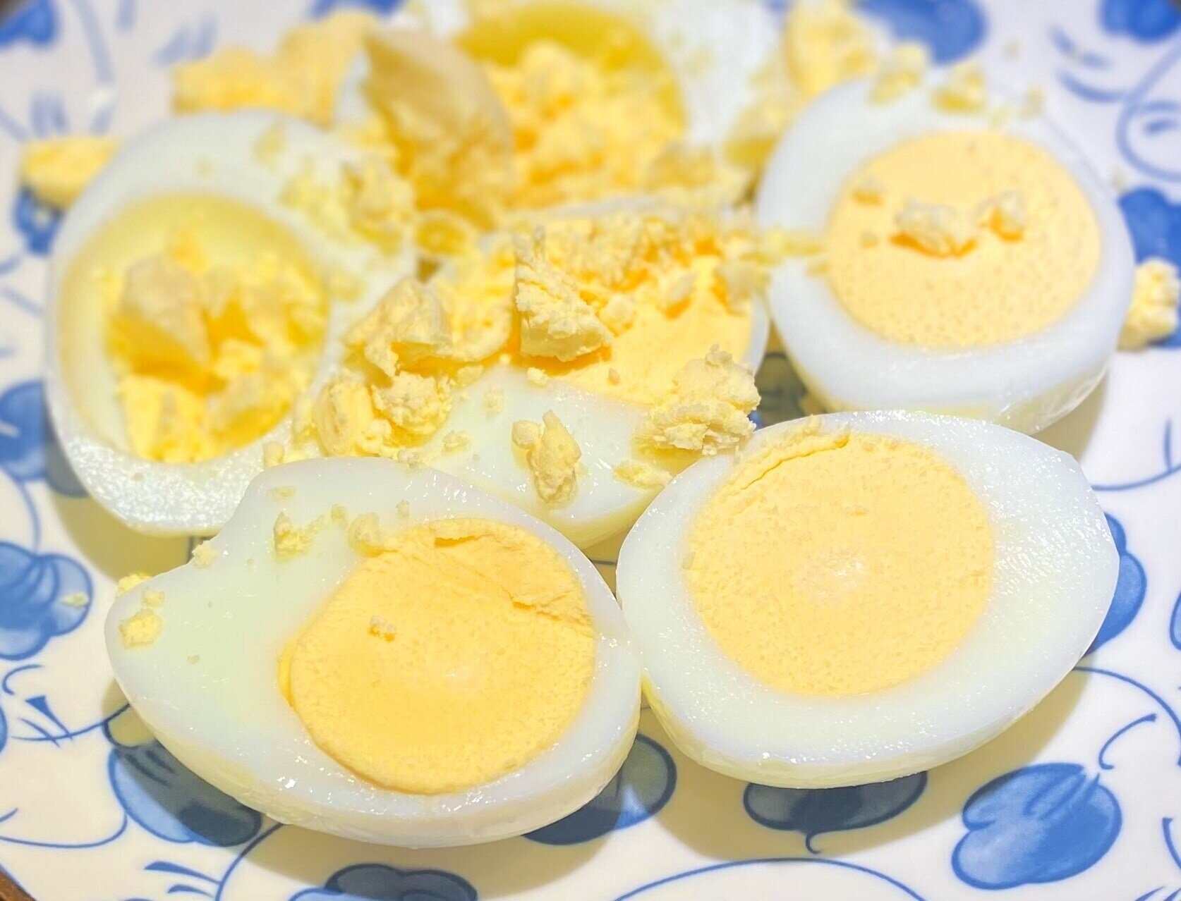 hardboiled eggs slice in half on a plate.