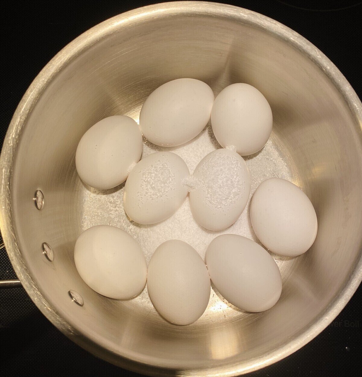 Eggs in a pot with salt.