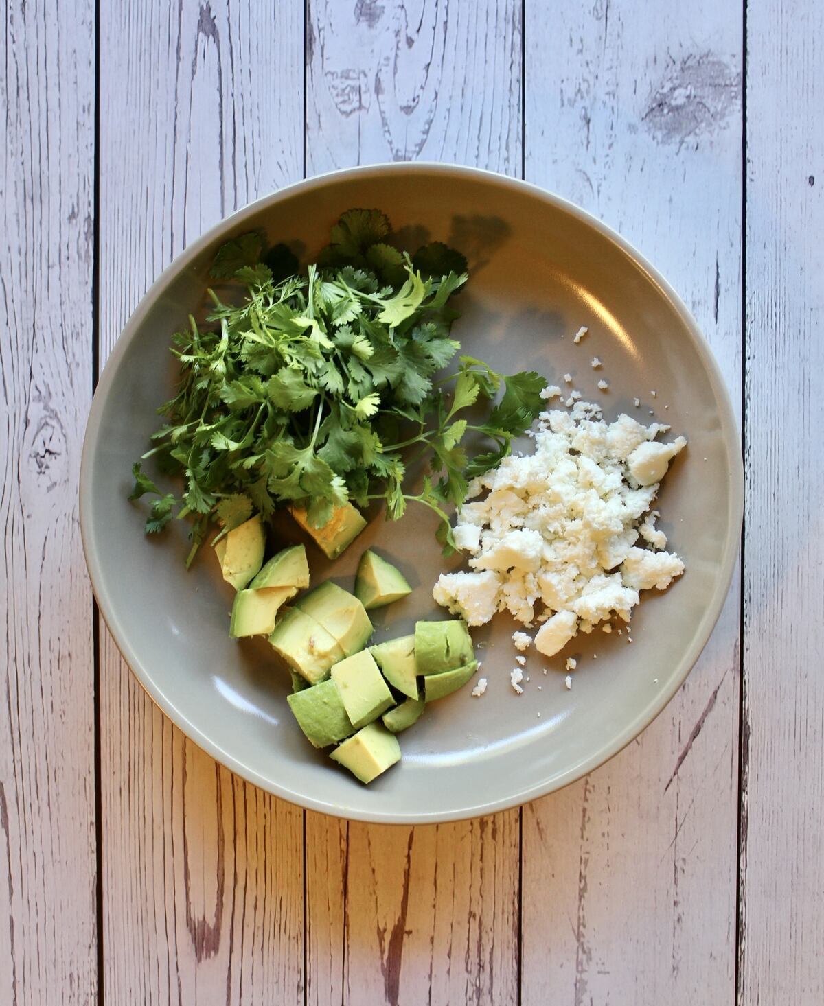 The garnishes for hearty chicken tortilla soup.