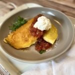 smash breakfast tacos with salsa and sour cream.