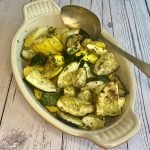 A serving dish of air fryer zucchini and yellow squash with a serving spoon.