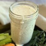 A mason jar of the best homemade ranch dressing with a drip falling down the side.