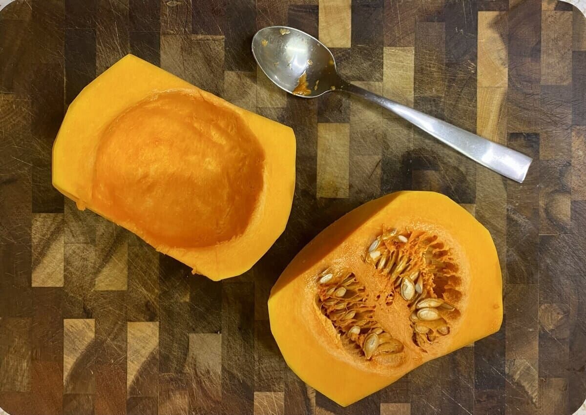 The bulb of the butternut squash halved with seeds scooped out.