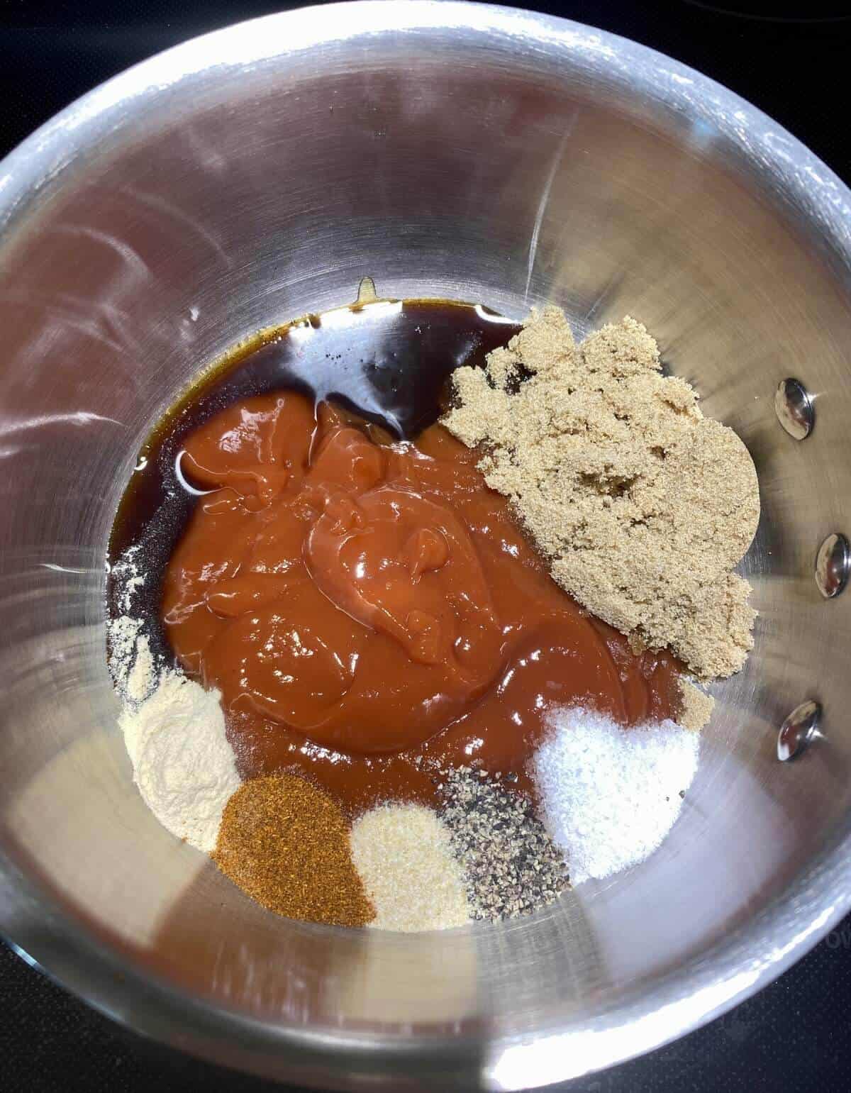 The bbq sauce ingredients measured into a small pot on the stove.