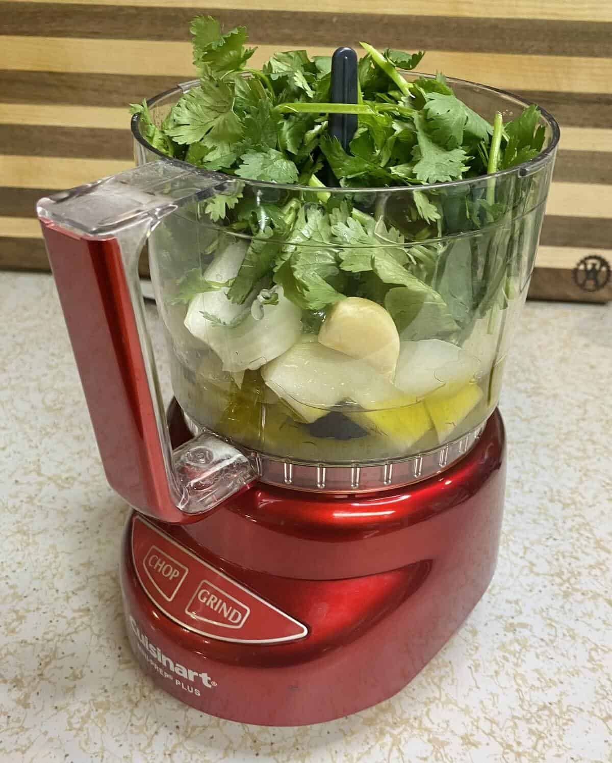 The green sauce ingredients in the food processor before blending.