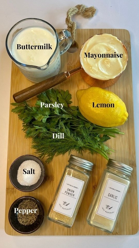 All the ingredients needed to make the ranch dressing on a cutting board and labeled.