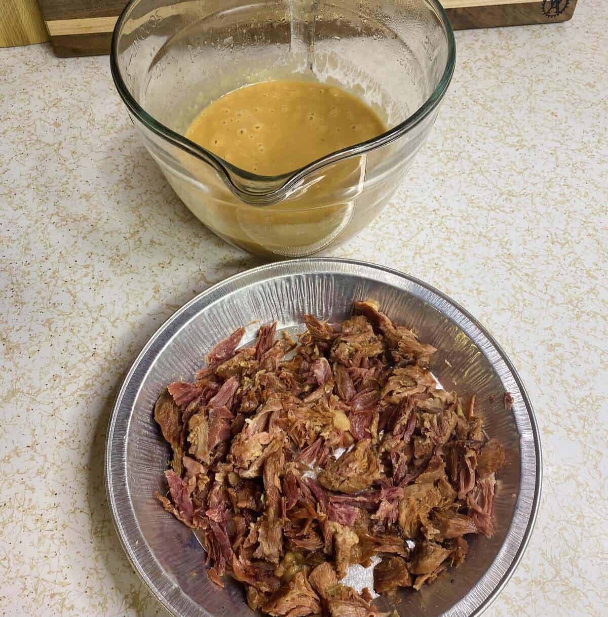 A pureed pitcher of beans and the ham shredded from the bone.