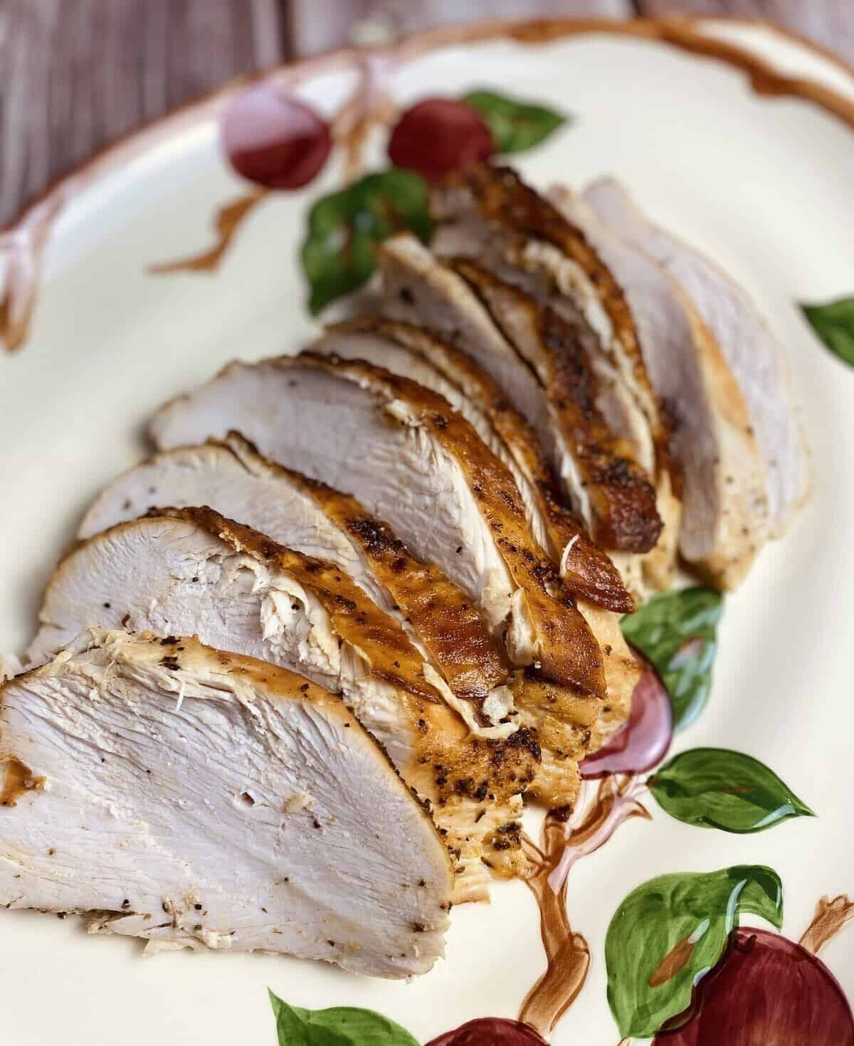 Sliced roasted turkey on a serving platter.