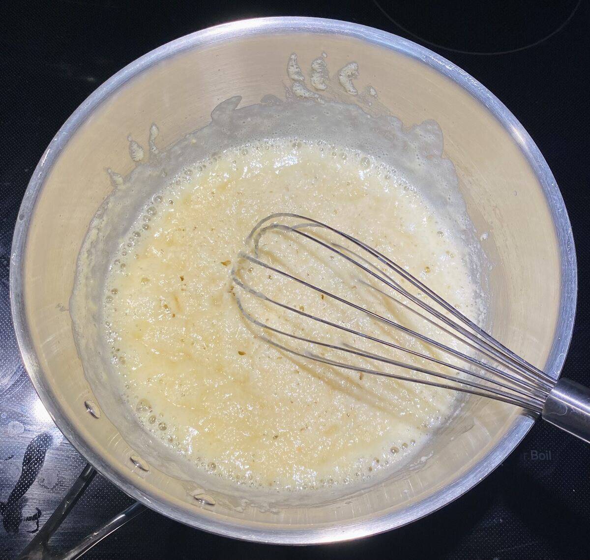 After the flour and butter have cooked and moisture is evaporating.