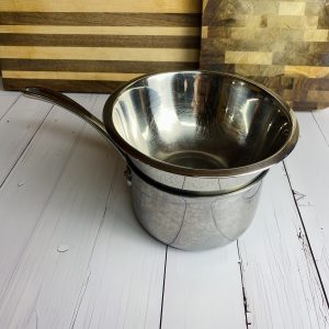 A small bowl sitting on a small pot for an example of a double boiler.