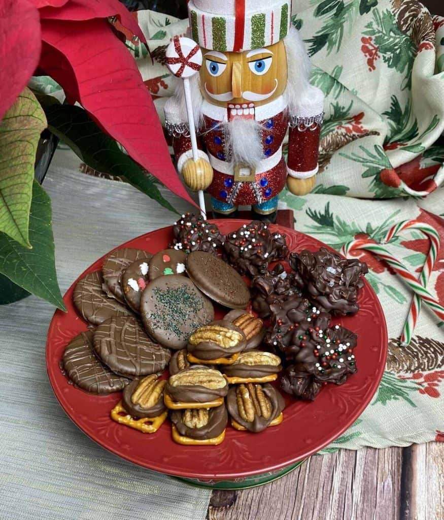 Three easy christmas treats on a red plate with a nutcracker and candy canes in the background.