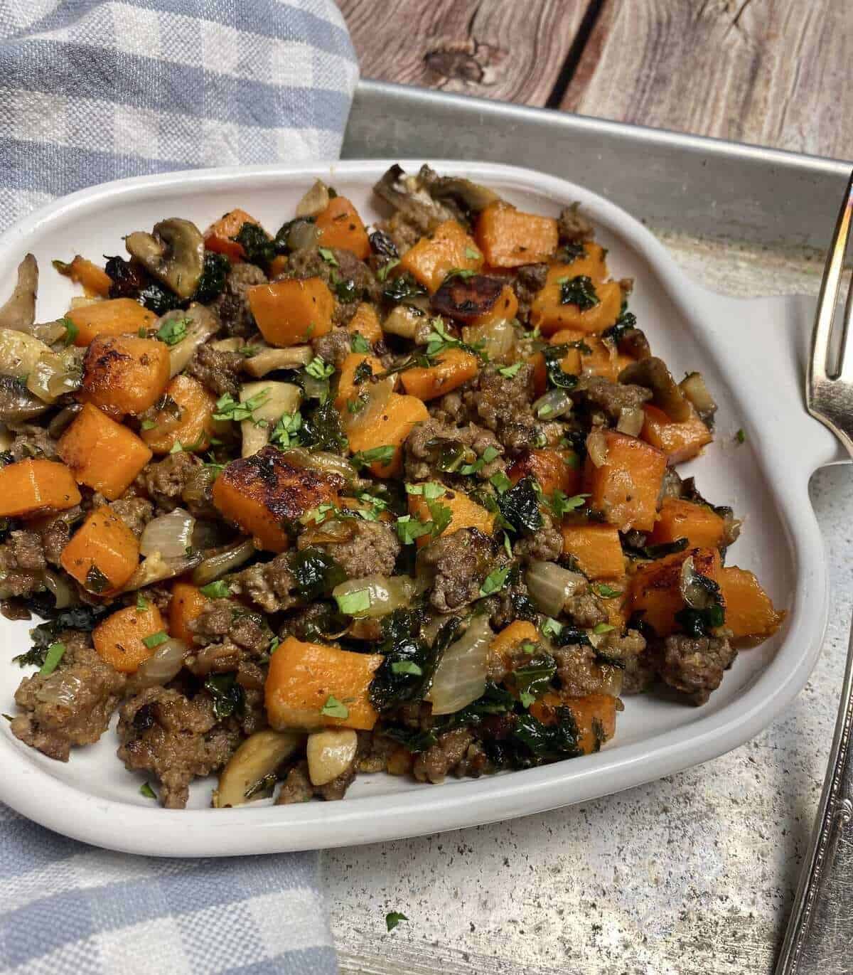 A closeup of the hash on a plate with a fork.