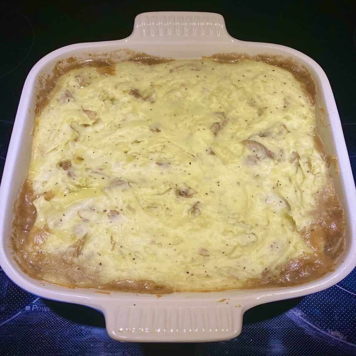 The casserole after it has baked showing the gravy bubbling up the sides.