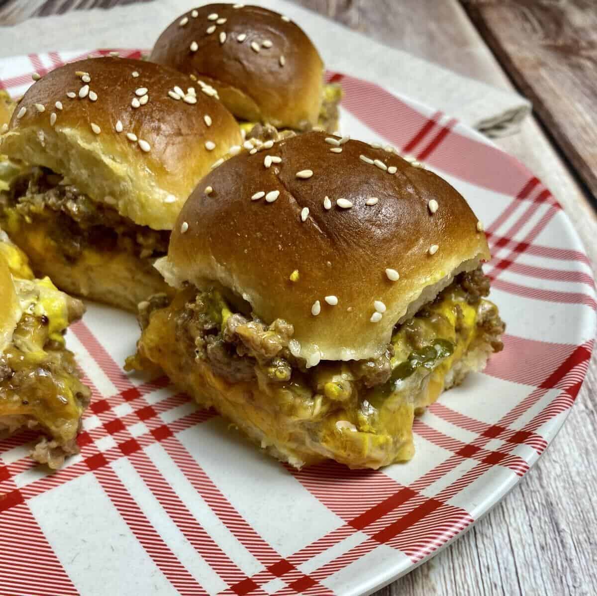 Single sliders on a plate with a napkin.