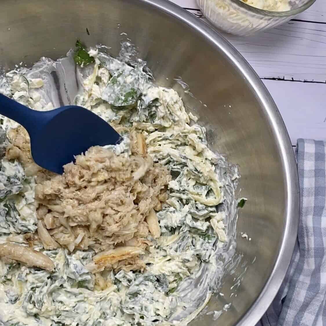 Stirring the crab into the rest of the ingredients.