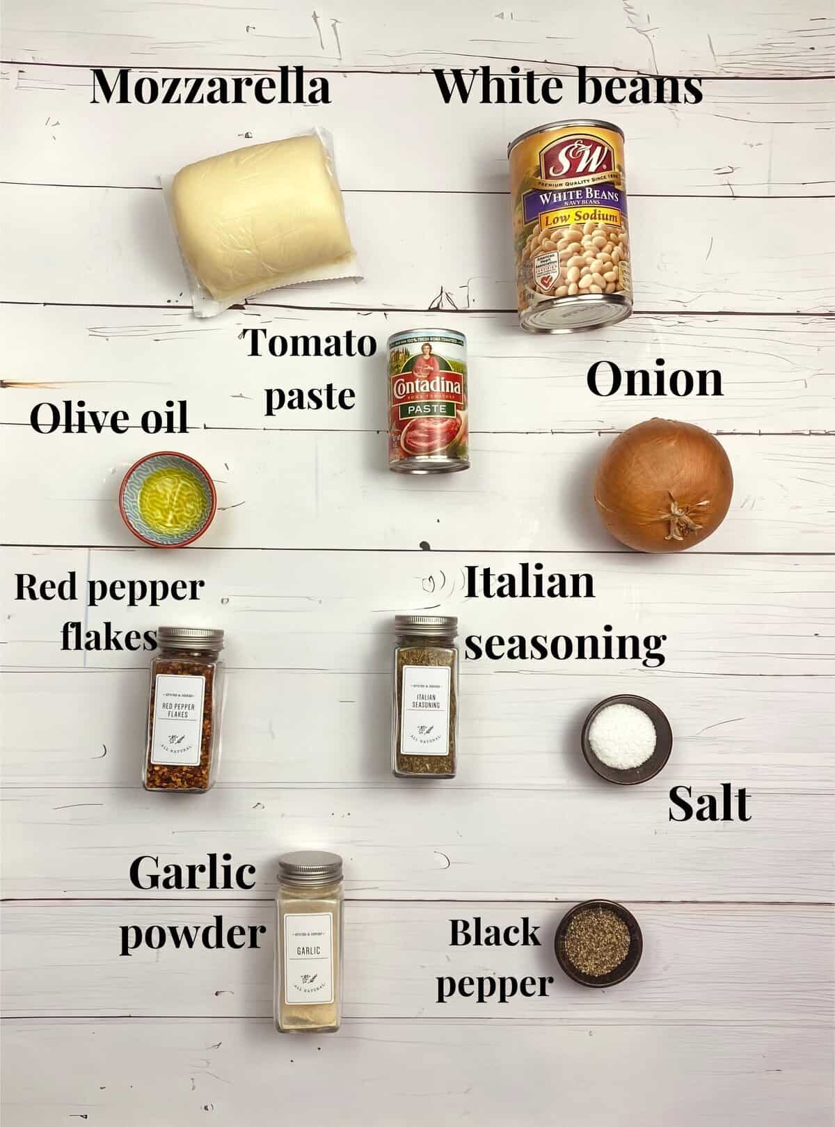 All the ingredients used to make cheesy white bean tomato bake.