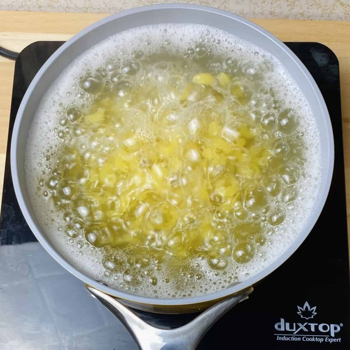 A pot of water boiling pasta.