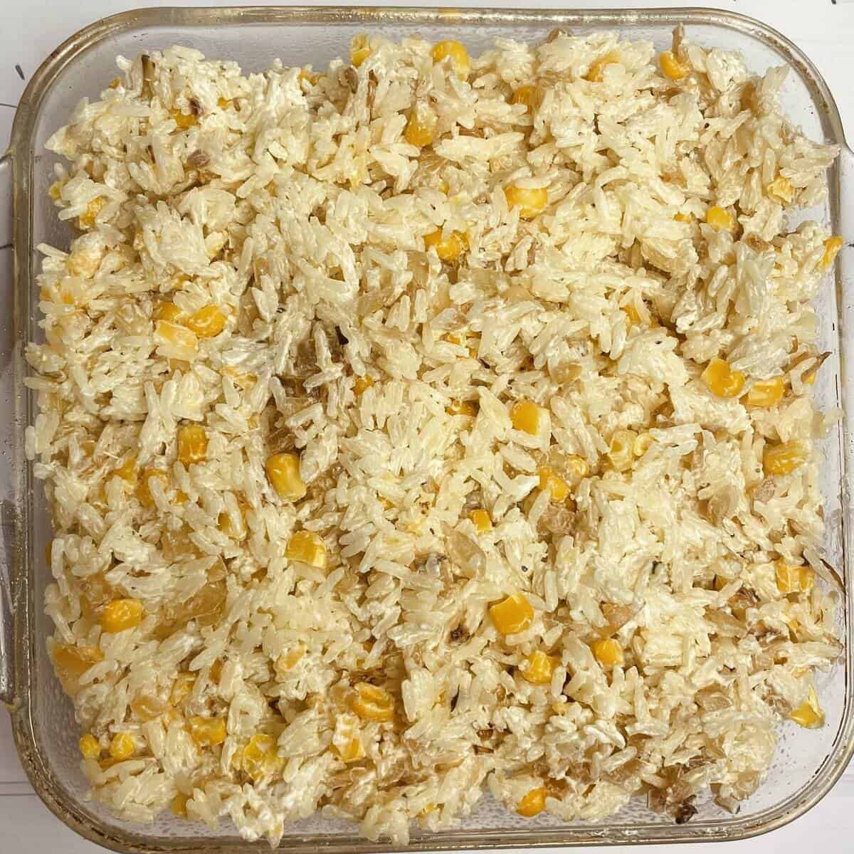 A baking dish filled with sour cream rice mixture.