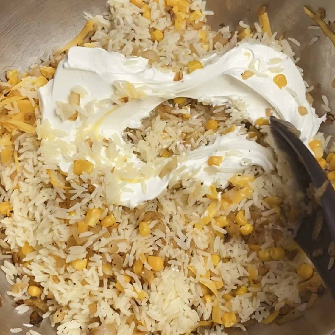 A close up of all the ingredients for sour cream rice mixed together.