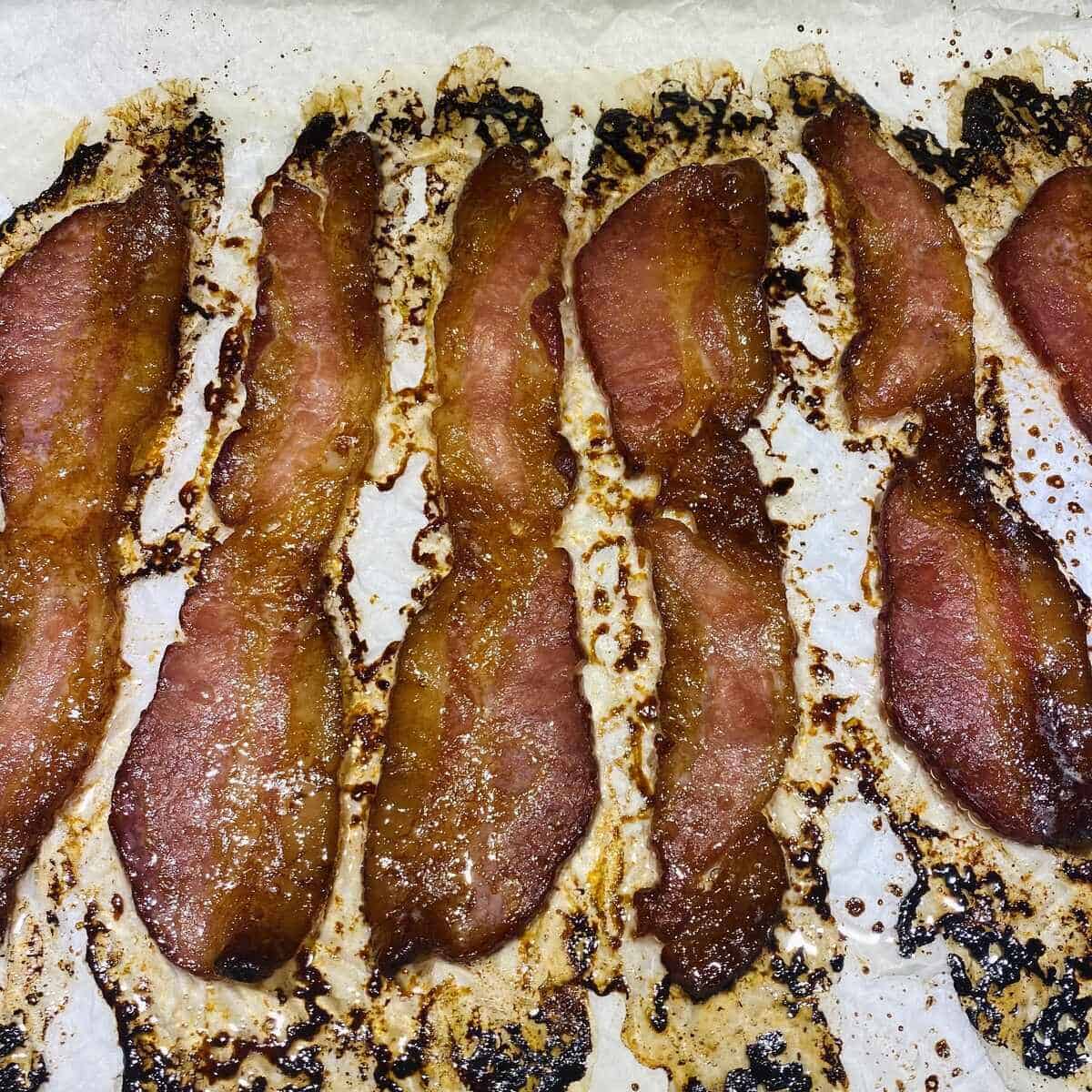 Cooked maple bacon on parchment.