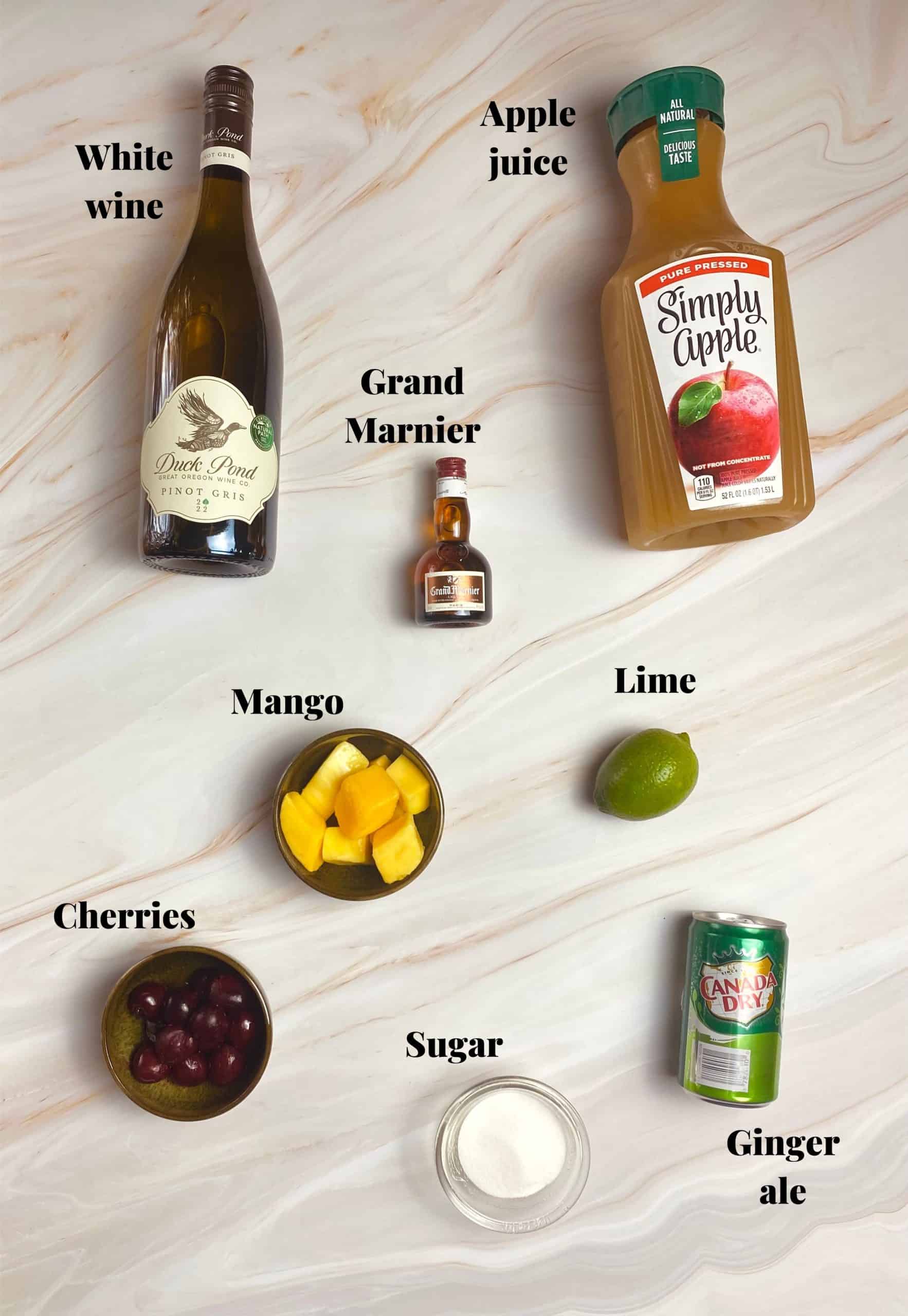 White sangria popsicle ingredients laid out on a table.