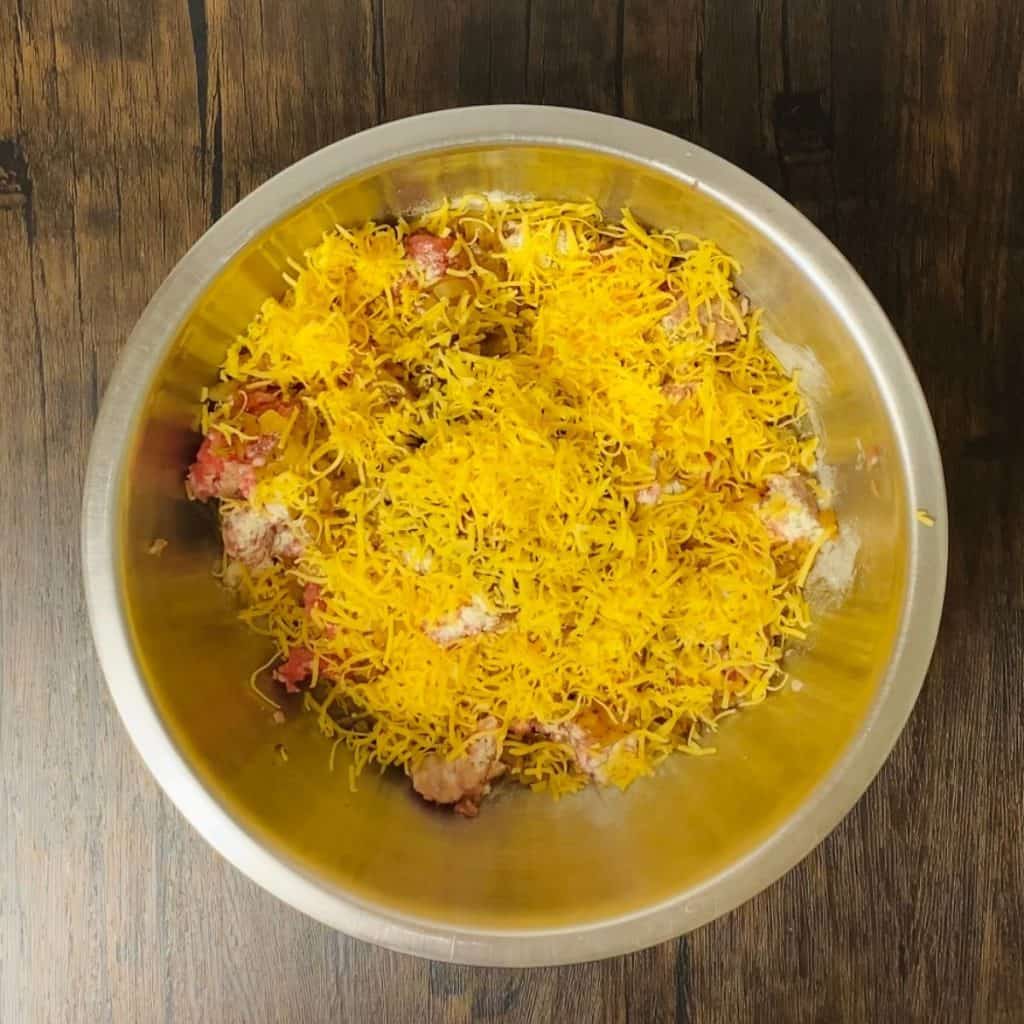 A bowl of all the ingredients needed to make bbq cheddar patties.