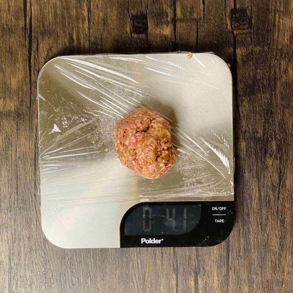 A ball of burger mixture on a digital scale.