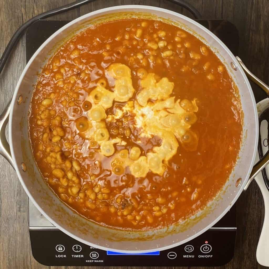 Cream added to the skillet of tomato soup.