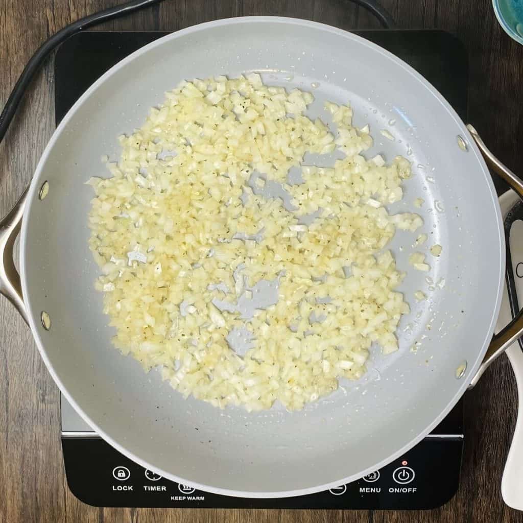 A skillet of onions cooking.