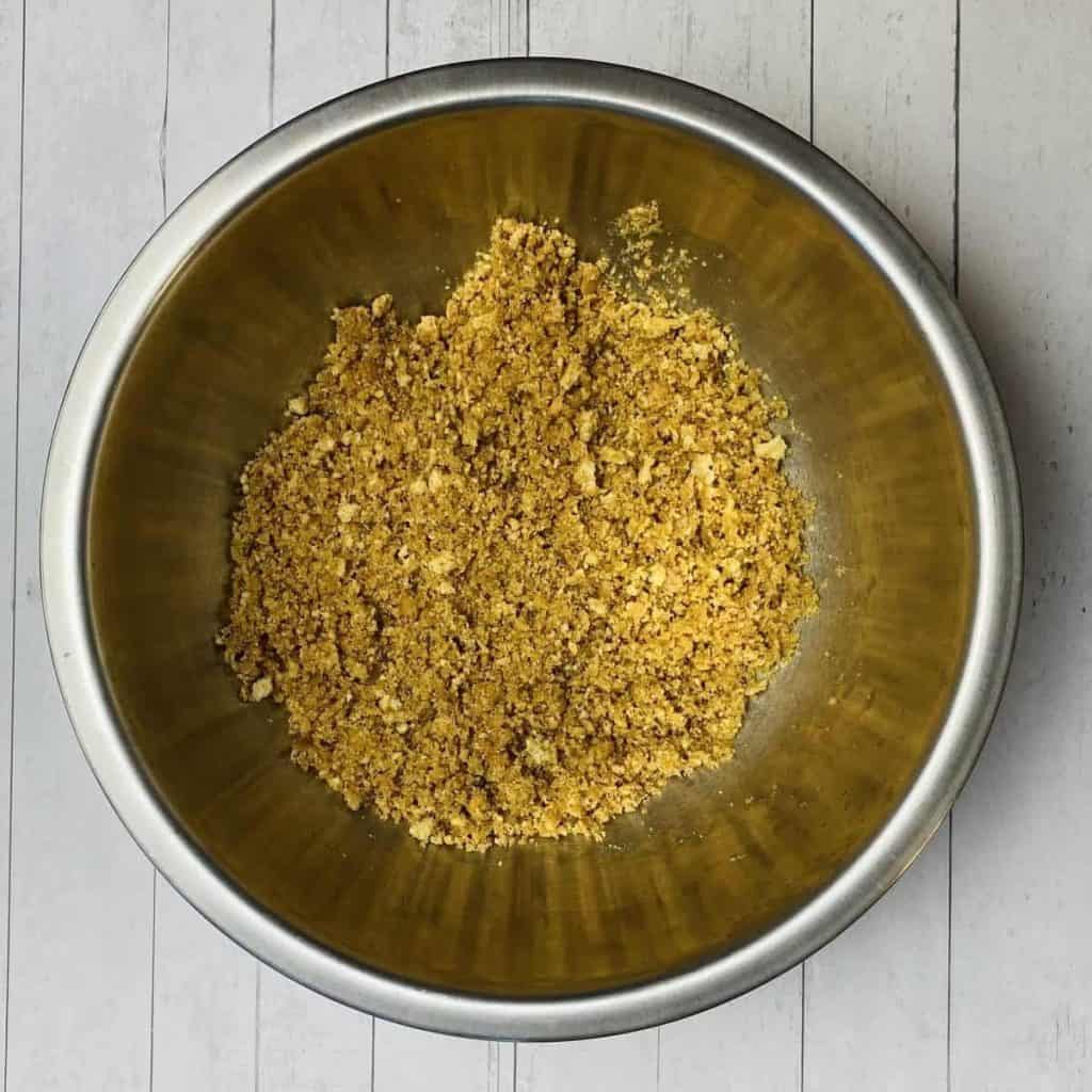 A bowl filled with butter soaked graham cracker crumbs.