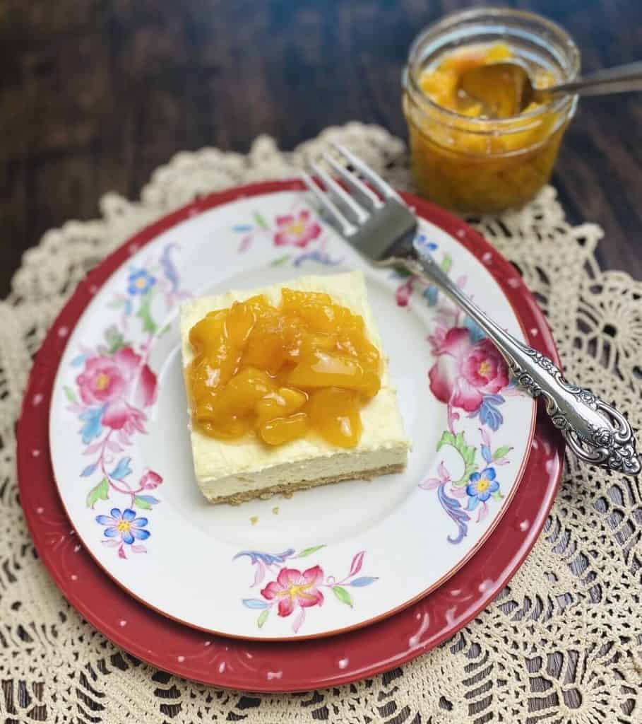 Peaches and cream dessert on a plate with a side of peach compote.