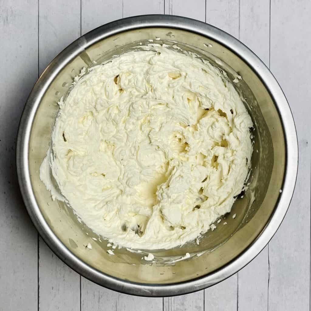 A bowl of prepared whipped cream.