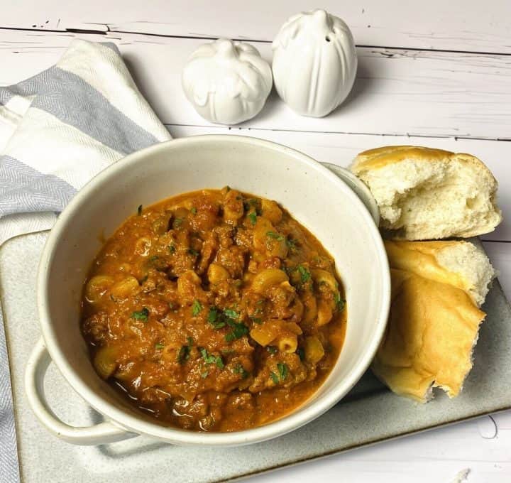 Goulash served on a plate with crusty bread.