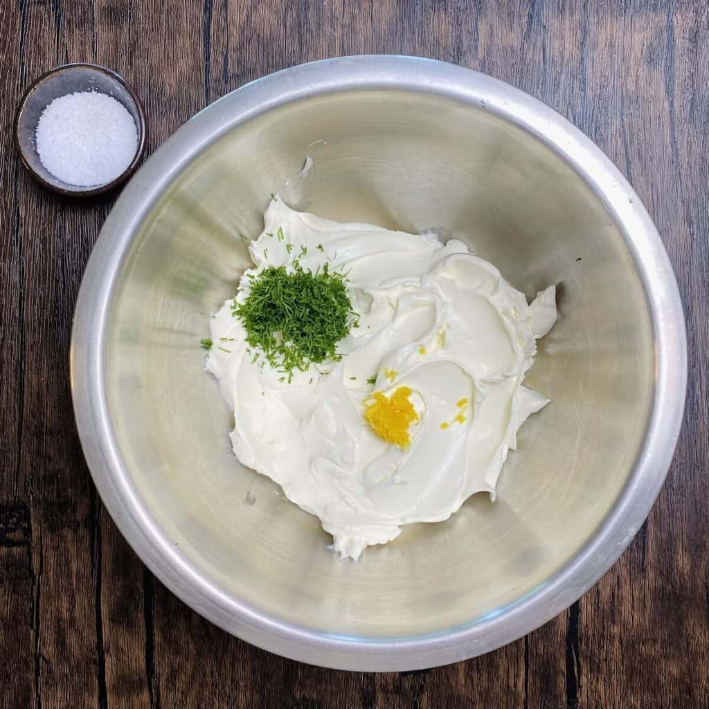 A bowl filled with the cream cheese mixture for the cucumber sandwich.