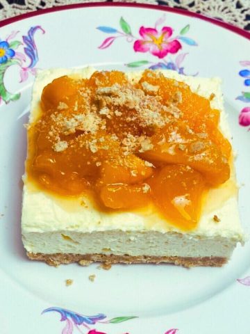 A serving of no bake peaches and cream dessert on a floral plate.