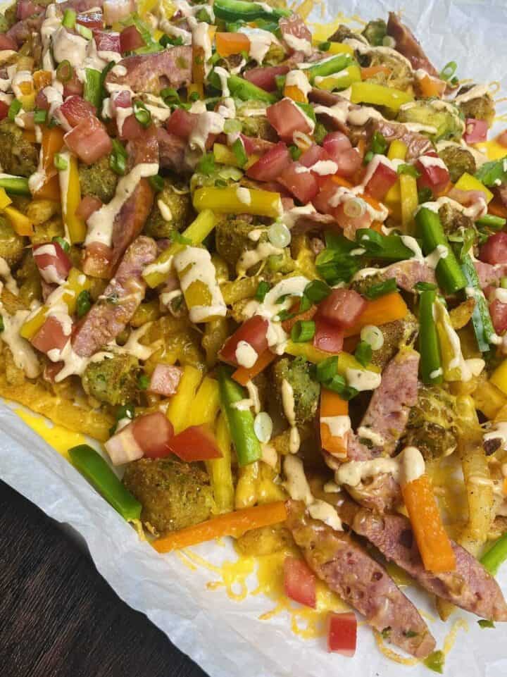 A top view of dirty fries on a sheet pan.