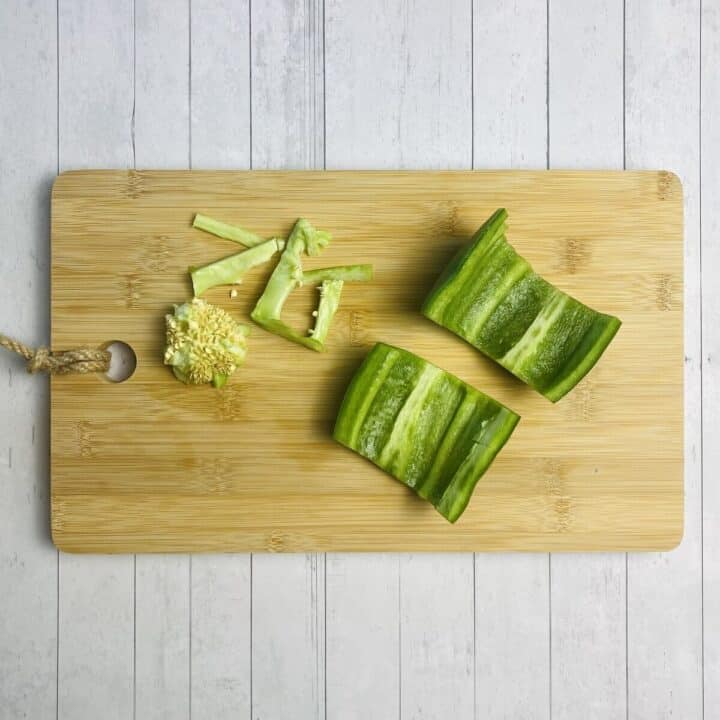 A bell pepper on a cutting board with the seeds removed.