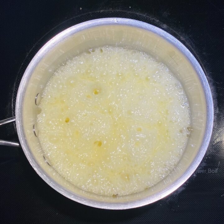 A soup pot holding boiling sugar.