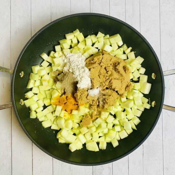 All the apple filling ingredients cooking in a nonstick pan.